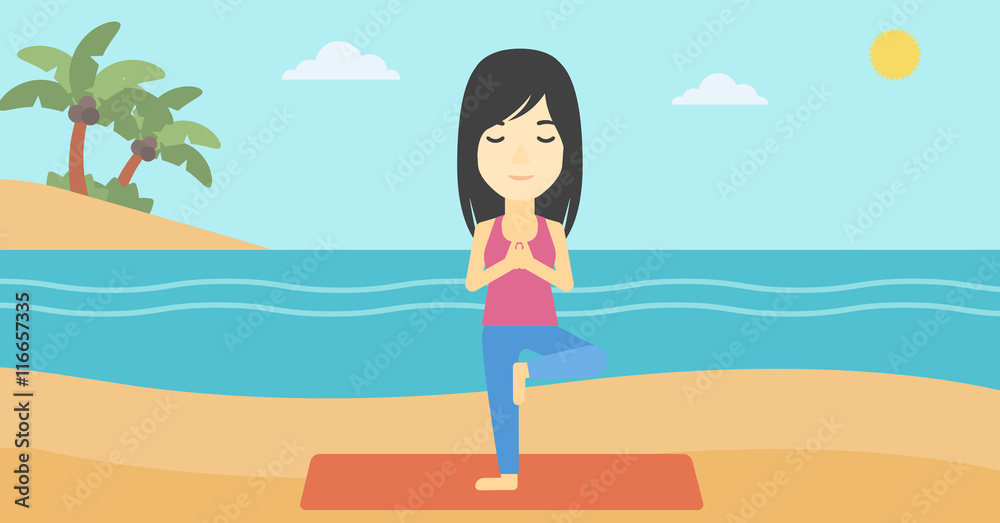 Woman practicing yoga tree pose on the beach.