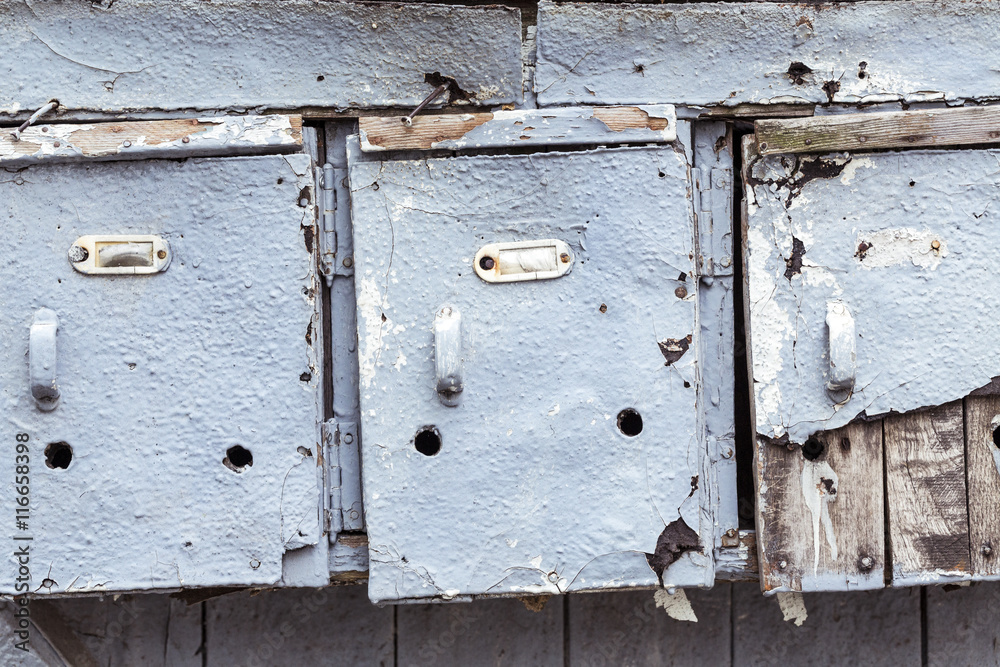 three very old and grungy mailboxes three very old and grungy mailboxes