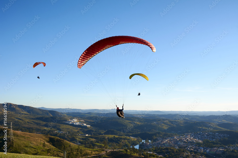 Paragliding flying over mountains Paragliding flying over mountains