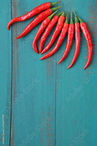 Vertical flat lay view of hot red chili peppers