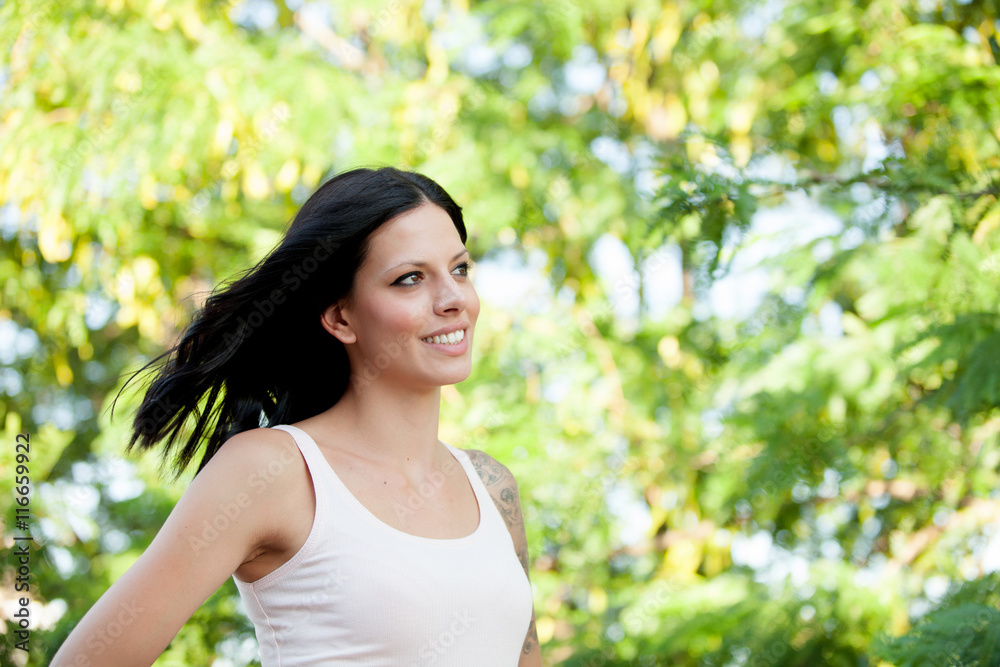 Beautiful brunette girl relaxing in the park Beautiful brunette girl relaxing in the park