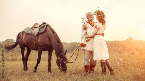 Dating of mature man and woman on the rural summer background.