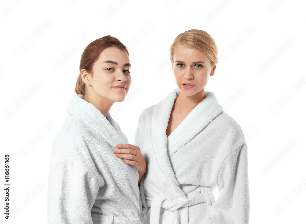 Two beautiful women in dressing gowns isolated on white Two beautiful women in dressing gowns isolated on white