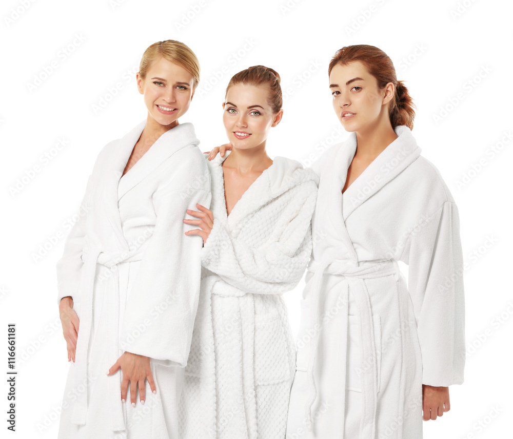 Three beautiful women in dressing gowns isolated on white Three beautiful women in dressing gowns isolated on white