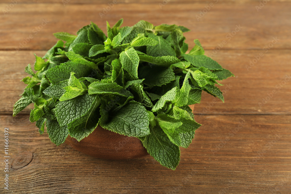 Fresh bunch of mint on wooden table Fresh bunch of mint on wooden table