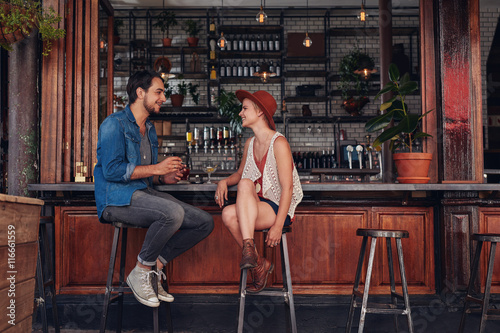 Young couple sitting at cafe counter