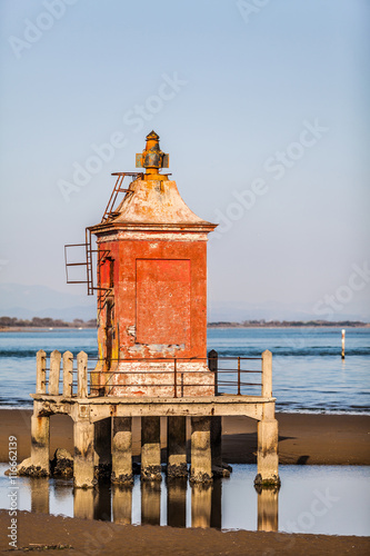 Little old rusty lighthouse in Lignano Bibbione Italy.