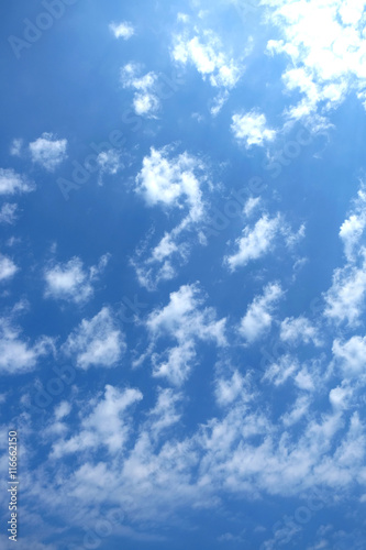 Beautiful celestial landscape with white clouds high in the stratosphere on a sunny summer day vertical view