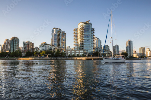 Sail boat in False Creek with the view on the residential buildings in Downtown Vancouver  BC  Canada.