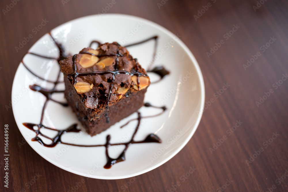 Brownies with chocolate sauce topping on white plate Brownies with chocolate sauce topping on white plate