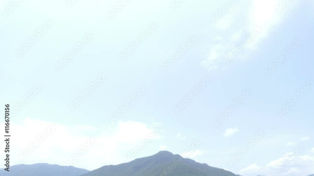 scenic view of meadow and mountain in countryside of thailand (tilt down)