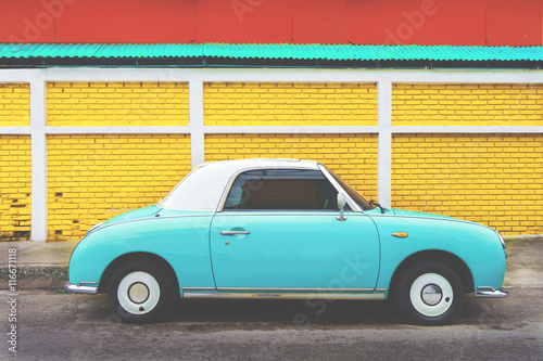 Fototapeta Naklejka Na Ścianę i Meble -  Side view of classic car parked on street in city - vintage retro color effect styles