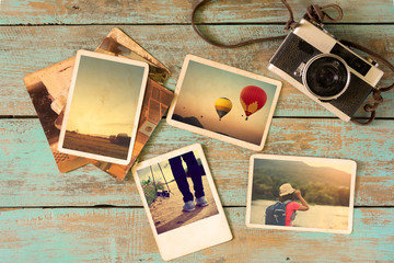 Photo album remembrance and nostalgia in summer journey trip on wood table. instant photo of vintage camera - vintage and retro style