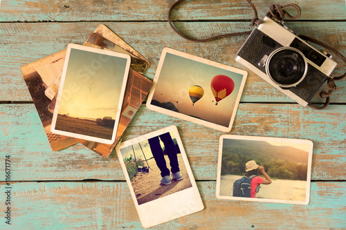 Photo album remembrance and nostalgia in summer journey trip on wood table. instant photo of vintage camera - vintage and retro style