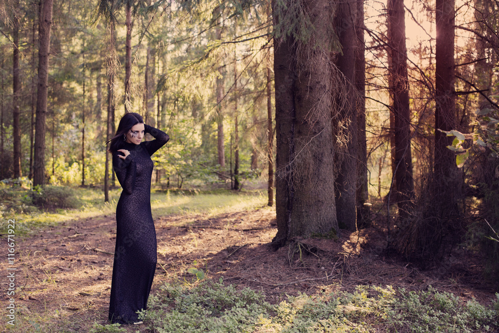 Beautiful witch posing in a mystic forest Beautiful witch posing in a mystic forest
