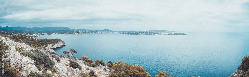 Panoramic view from rocky cliff toward ocean