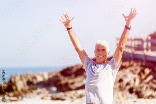 Young man in sport wear with outstretched arms © Sergey Nivens