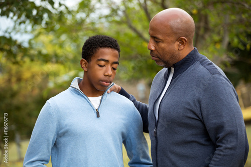 Fotografie African American father and son in deep conversation.
