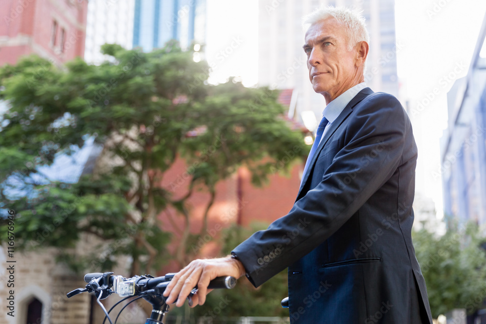 Fototapeta premium Successful businessman riding bicycle