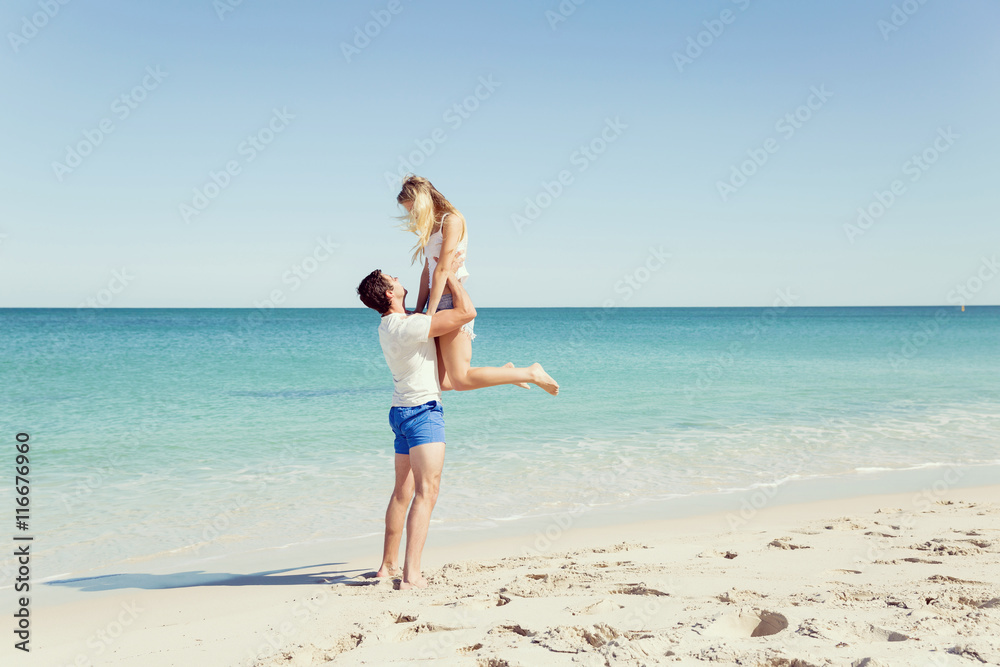 Happy couple jumping on beach vacations Happy couple jumping on beach vacations