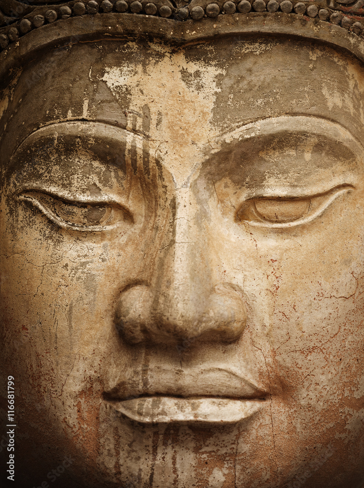 Ancient stone Buddha face close up