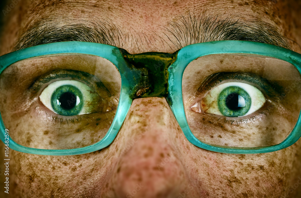 Fototapeta premium Frightened look of a man in old glasses
