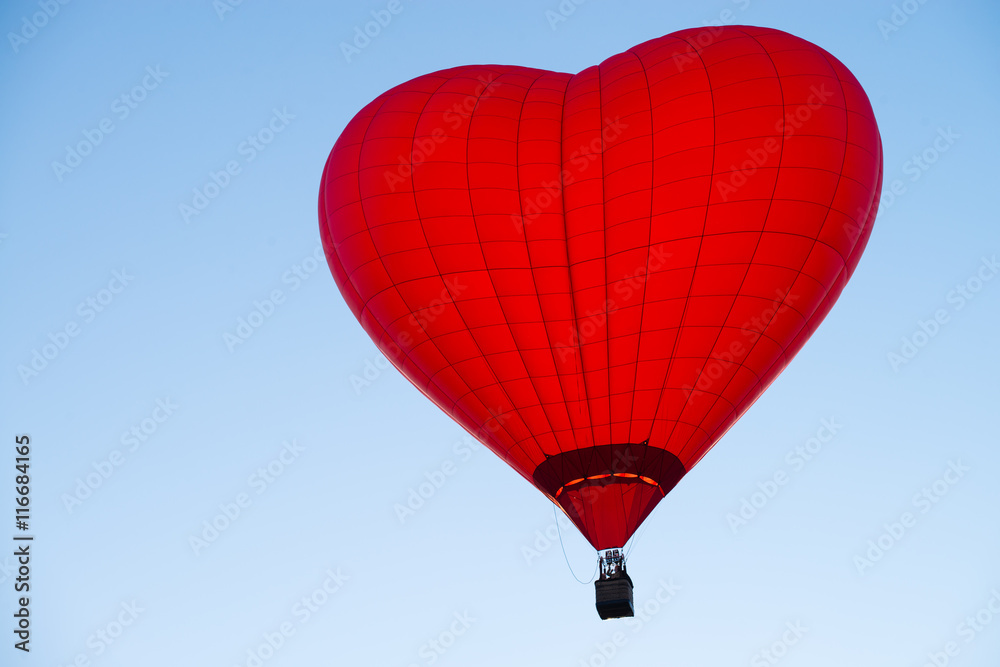 Fototapeta premium balloon in the form of heart against a blue sky at sunset