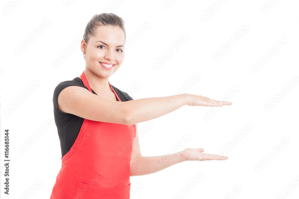 Joyful hypermarket seller holding something invisible in hands Joyful hypermarket seller holding something invisible in hands