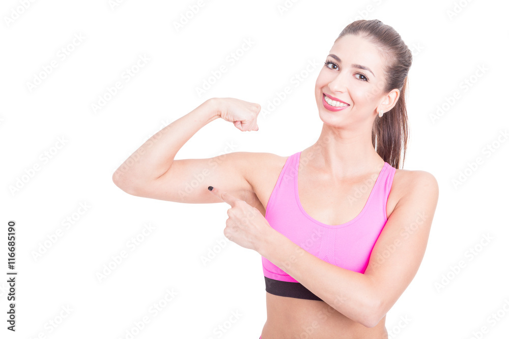 Female fitness trainer showing her biceps and smiling Female fitness trainer showing her biceps and smiling
