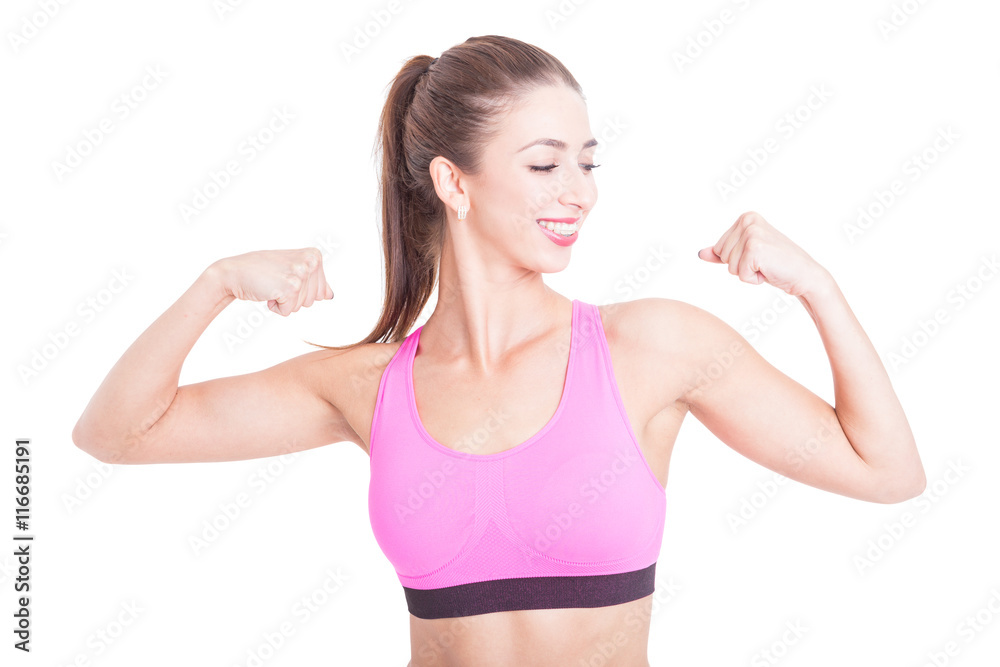 Fit girl smiling and showing her biceps Fit girl smiling and showing her biceps