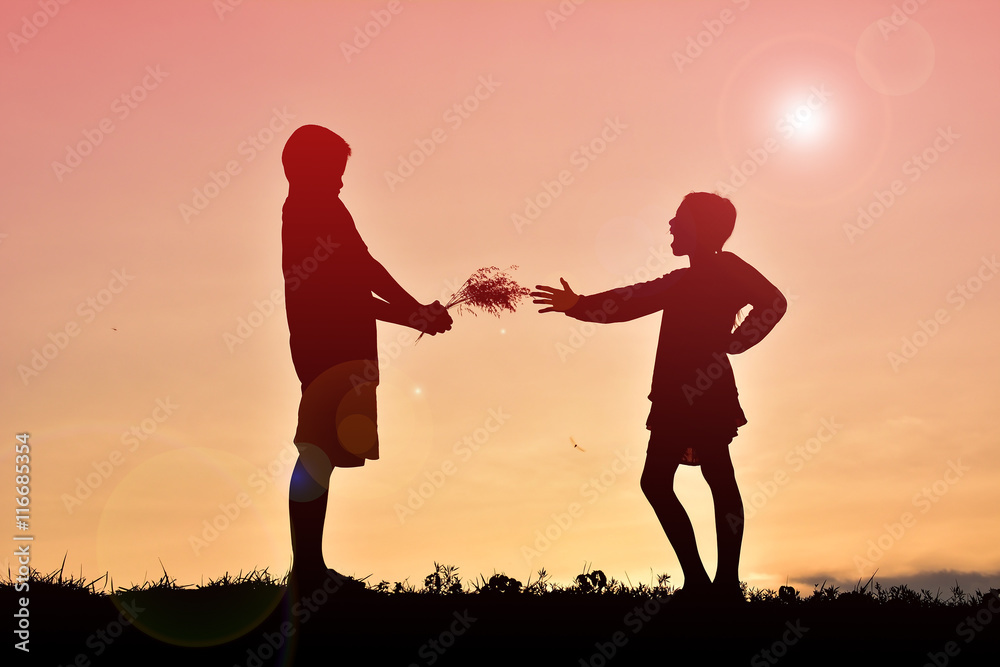 Silhouettes happy people playing at sunset. 