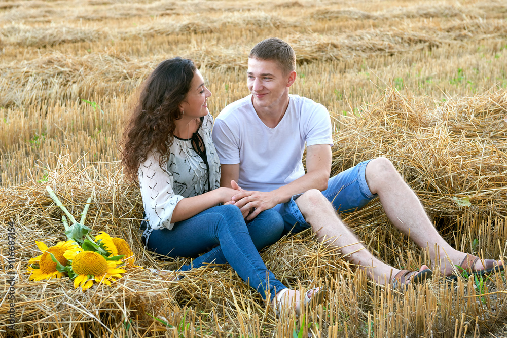 happy young couple sit in wheaten field at evening, romantic people concept, beautiful landscape, summer season happy young couple sit in wheaten field at evening, romantic people concept, beautiful landscape, summer season
