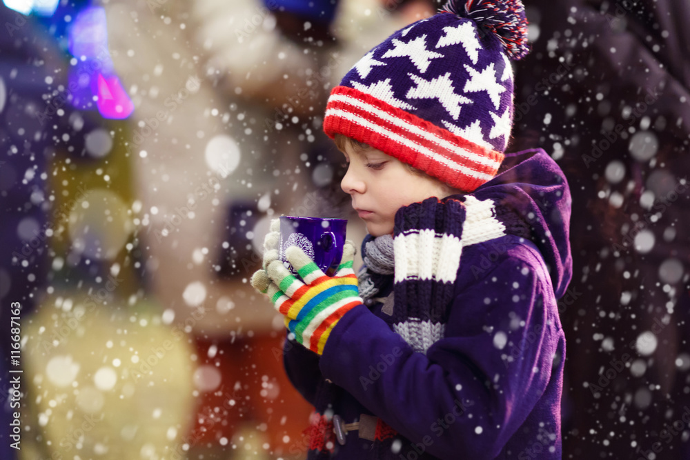 Little kid boy with hot chocolate on Christmas market Little kid boy with hot chocolate on Christmas market