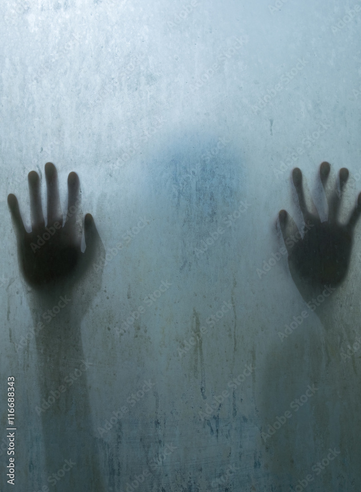 Fototapeta premium Hand person shadow behind translucent mirror stain