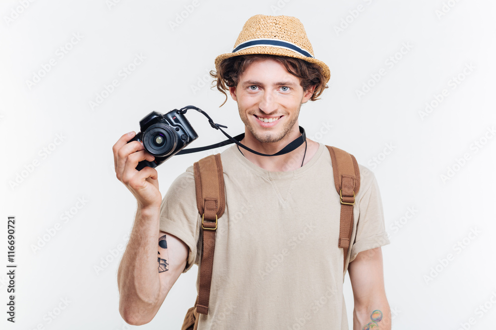Young smiling man holding retro camera Young smiling man holding retro camera