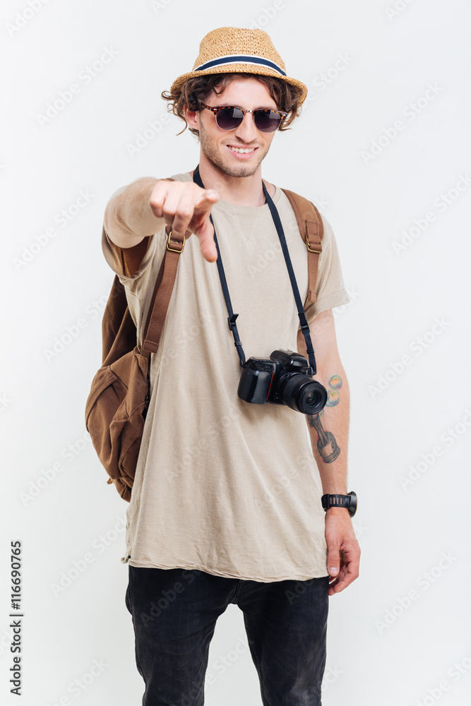 Young smiling man pointing finger at camera Young smiling man pointing finger at camera