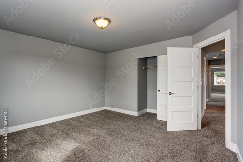 Small basement room interior with grey walls and white trim.