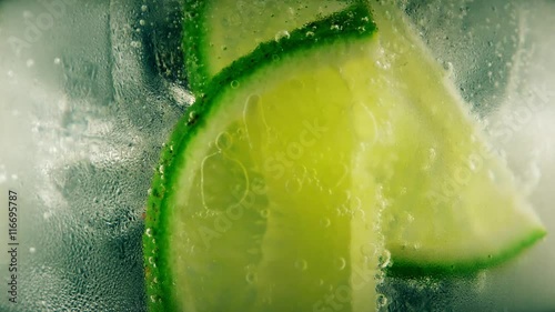 Cold cocktail with lime, tonic and ice, closeup