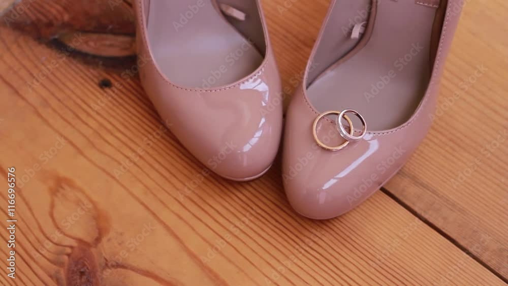Bride shoes on wood background, wedding ring. Bride shoes on wood background, wedding ring.