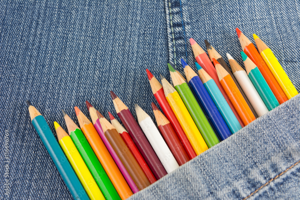 Colorful pencils in denim jeans pocket Colorful pencils in denim jeans pocket