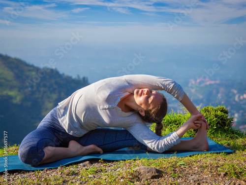 Young sporty fit woman doing Hatha Yoga asana