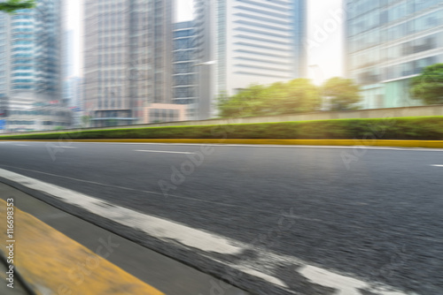 clean asphalt road with city skyline background,china. © kalafoto