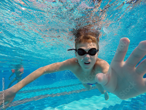 boy diving into a swimming pool