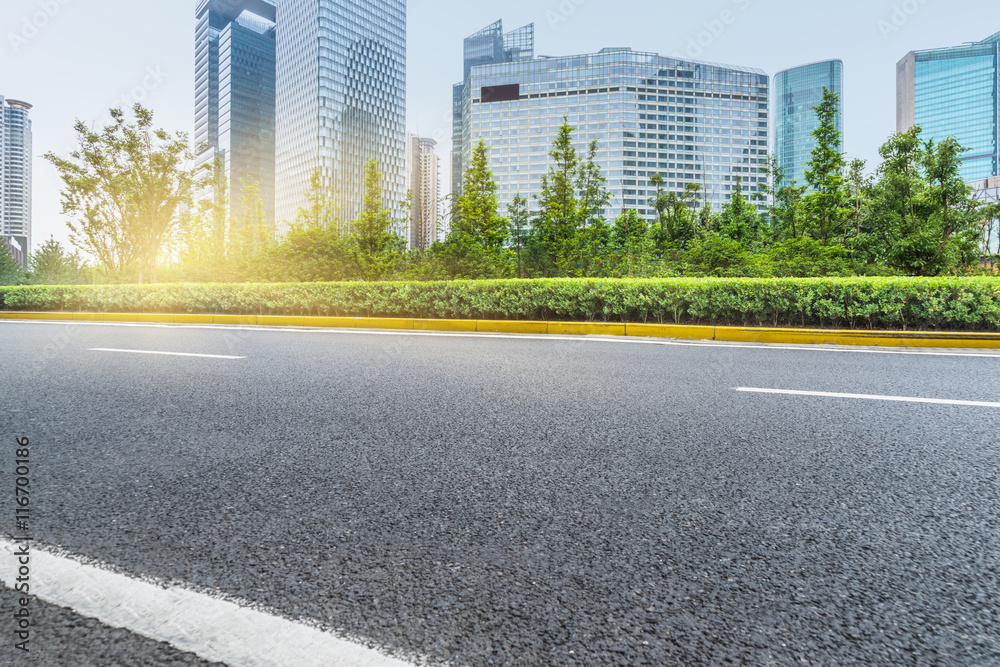 clean asphalt road with city skyline background,china. clean asphalt road with city skyline background,china.