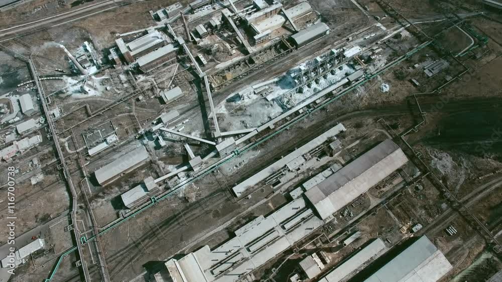 Aerial directly above view of large factory consisting of various industrial buildings and constructions Aerial directly above view of large factory consisting of various industrial buildings and constructions