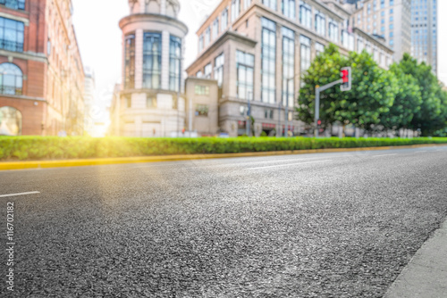 clean asphalt road with city skyline background,china.