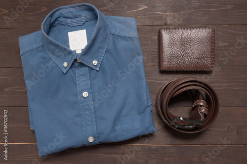elegant set: brown leather belt, blue shirt, brown wallet, on th