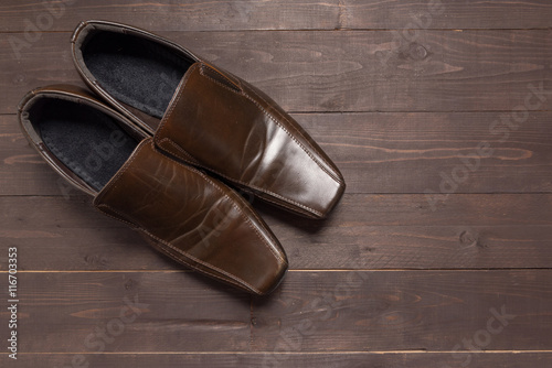 Leather shoes are on the wooden background