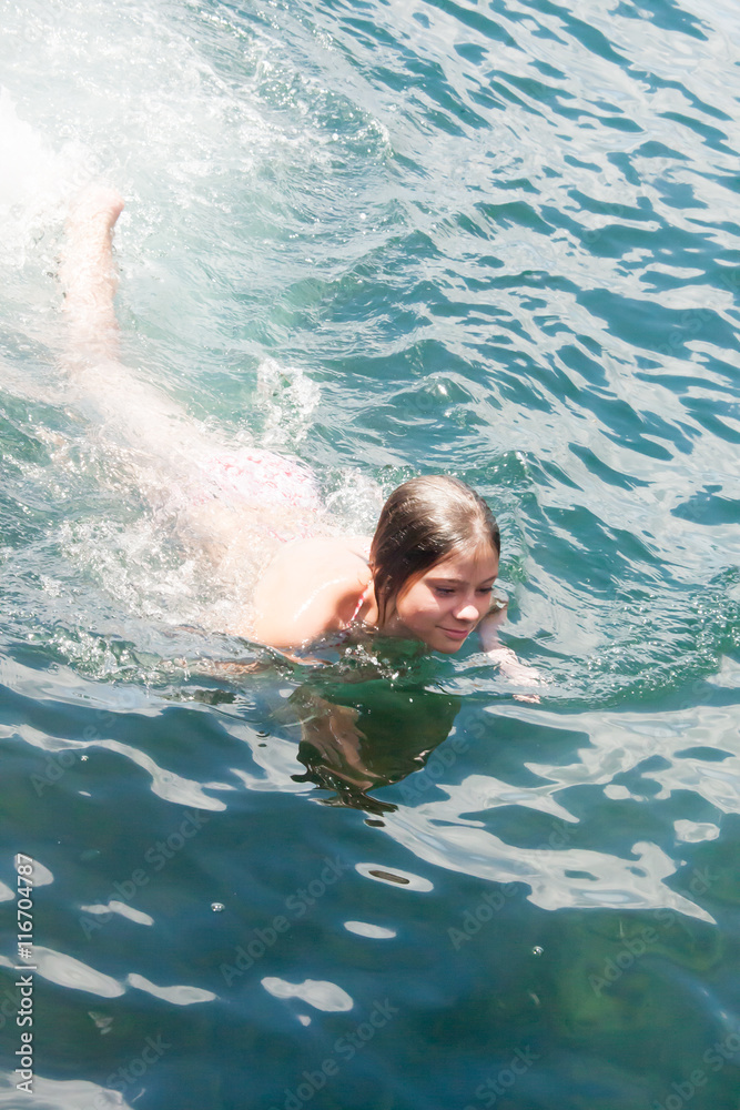 Young woman swimming in ocean