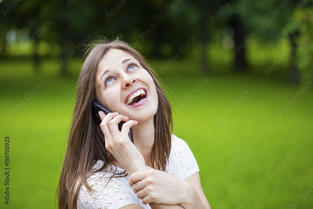 Portrait of beautiful dark haired young woman speaking on mobile Portrait of beautiful dark haired young woman speaking on mobile